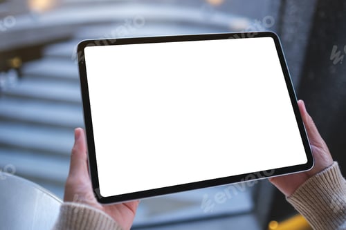Preview: Mockup image of a woman holding digital tablet with blank white desktop screen in cafe