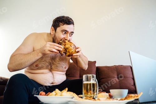 Preview: portrait of a caucasian fat man eating chicken grill on the sofa. looking at camera,