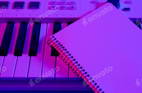 Preview: Close-up, notepad on musical keys in neon lighting.