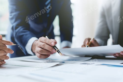 Preview: Businesspeople meeting together pointing to graph assess business profits.