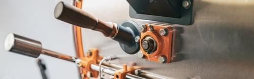 Preview: Close up of coffee roasting machine with coffee beans in small coffee manufacturing