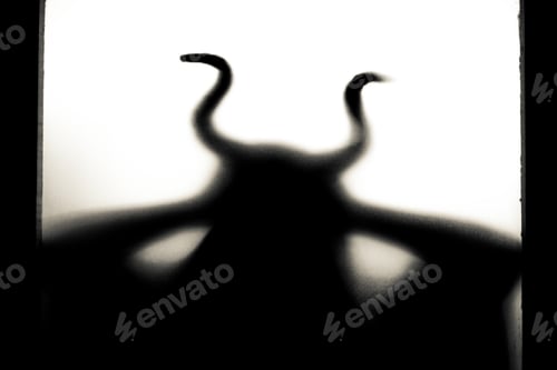 Preview: Horror, halloween background - Shadowy figure with horns behind the glass