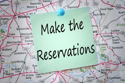 Preview: A green note saying Make the Reservations pinned to a map - travel planning concept