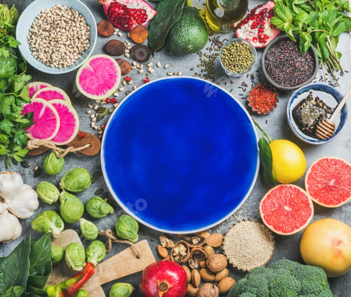 Preview: Healthy food over grey background, dark blue plate in center
