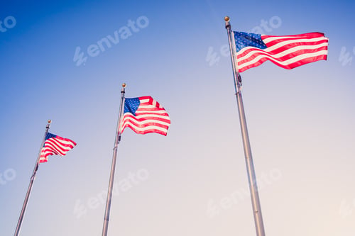 Preview: Flags of the United States waving in the blue sky
