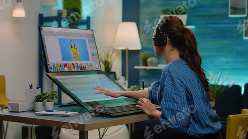 Preview: Woman photographer wearing headphones and editing pictures