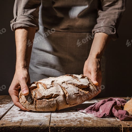 Preview: Baker or chef holding fresh made bread