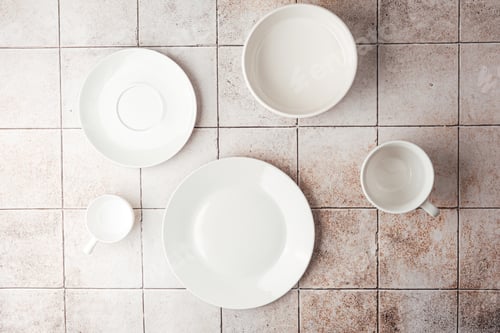 Preview: Assorted white ceramic tableware set on rustic tile background flat lay