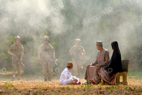 Preview: Soft blur of muslim family look to group of soldier come from the jungle during the battle