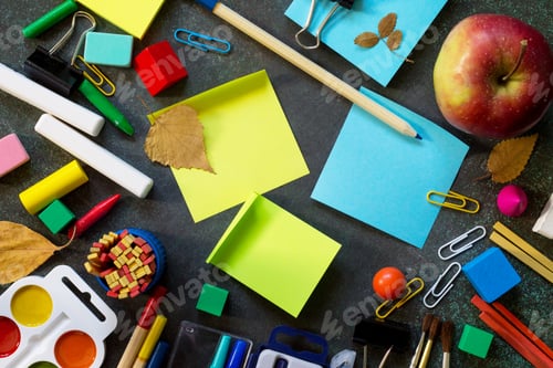 Preview: Back to school background with school supplies, apple on dark concrete or stone background.
