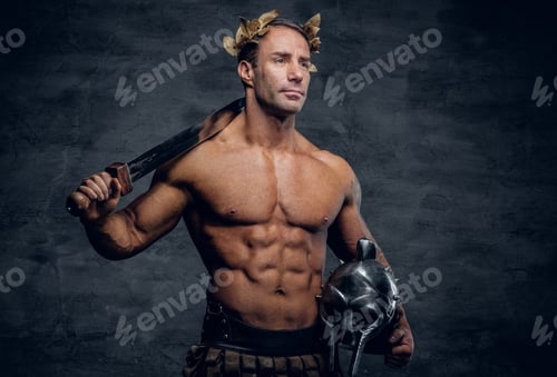 Preview: Middle age, muscular male holds silver gladiator helmet and an i