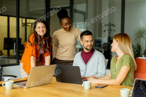 Preview: Young multiethnic startup team working in the modern office