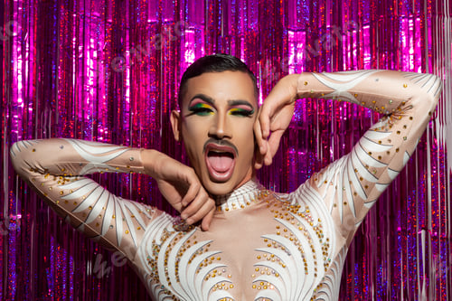 Preview: young gay man with makeup happy smiling with a colorful background