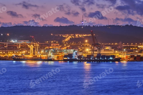 Preview: View of Lisbon port with port cranes in the evening