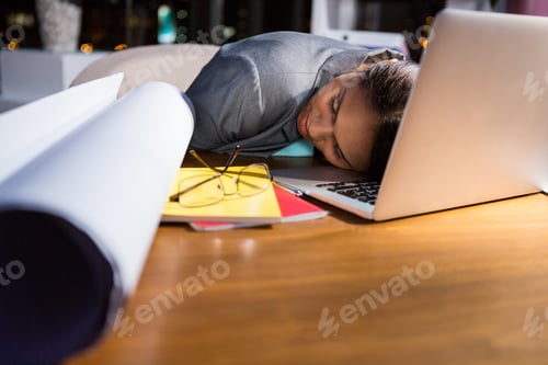 Preview: Businesswoman sleeping while working in office