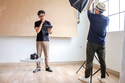 Preview: Photography Man Setup Studio for Photo Session With Attention To Lighting And Direction