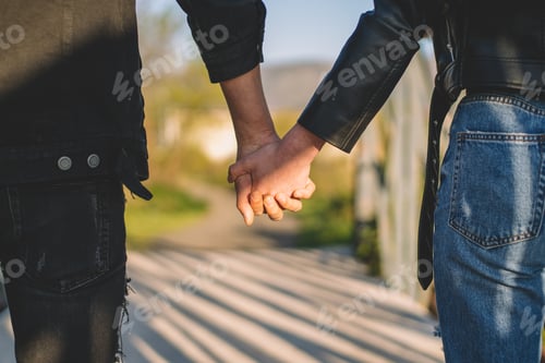 Preview: Young couple in love holding hands