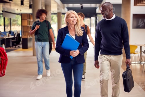 Preview: Male And Female Tutors In Busy University Or College Building With Students