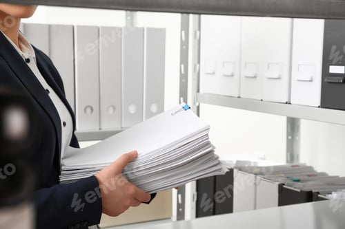 Preview: Female worker with documents in office, closeup
