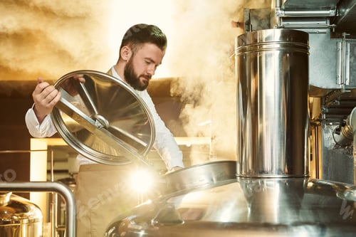 Preview: Brewer inspecting process of brewing beer with steam