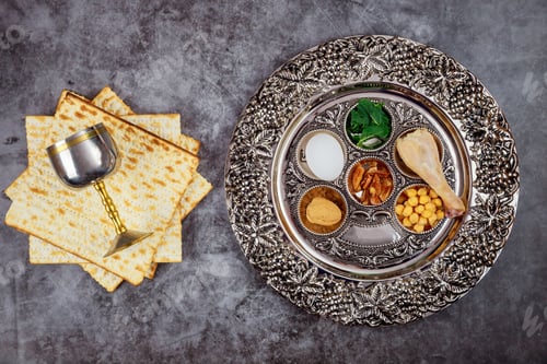 Preview: Jewish matzah bread with silver cup and flowers on wooden rustic background. Passover holiday concep