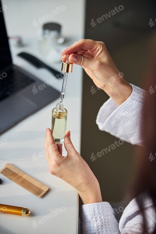 Preview: Close up of female hands that holding glass package