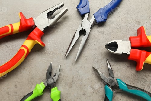 Preview: Different pliers on grey textured table, flat lay