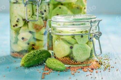 Preview: Natural pickled cucumber in jar with herbs