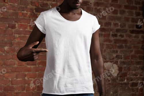 Preview: Fashion and design concept. Young attractive stylish dark-skinned male model dressed in white casual