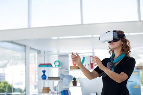 Preview: Female executive using virtual reality headset