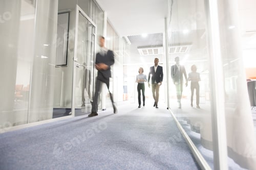 Preview: Business people walking in office corridor