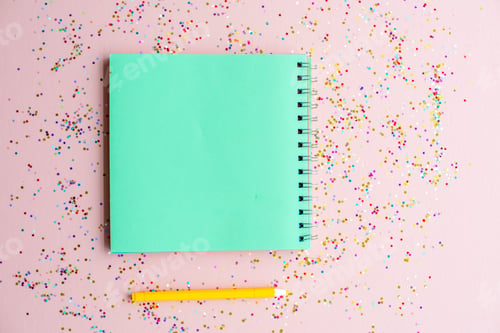 Preview: Blank notebook and pen with confetti