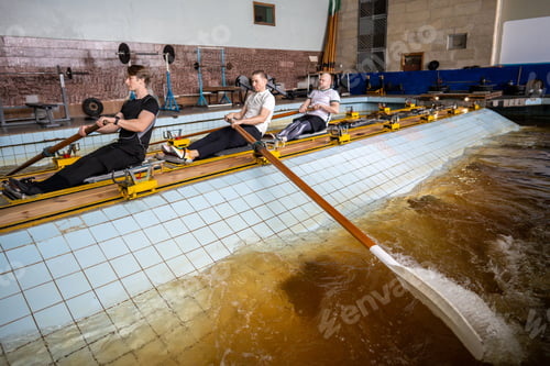 Preview: Rowing athletes skillfully manipulate oars, refining synchronization on rowing simulator in pool