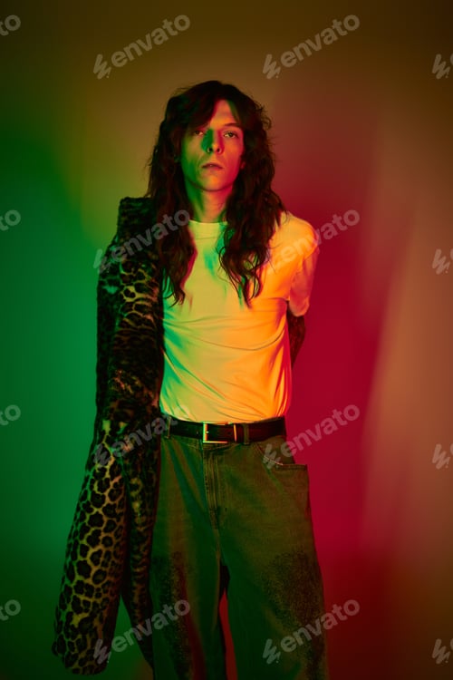 Preview: Handsome young man showcases unique fashion style with flair and confidence in vibrant setting