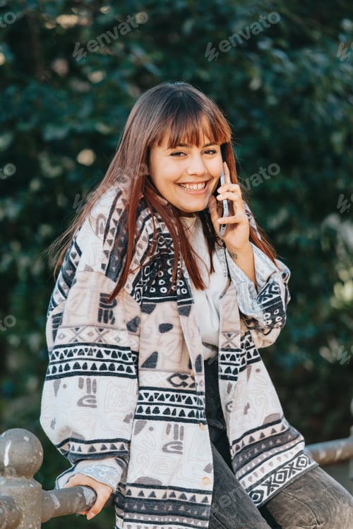 Preview: Hipster girl sitting on bench and using smart phone, Modern wearing,