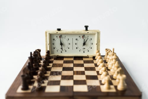 Preview: Chess board with figures set for new game and chess clock isolated on white