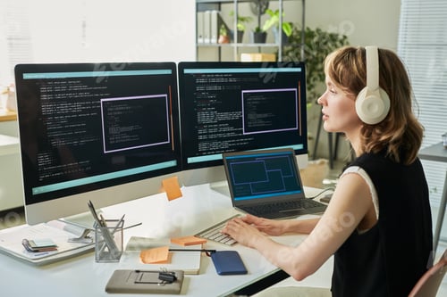 Preview: Young Caucasian Woman Developing Neural Network Code on Computer Monitors