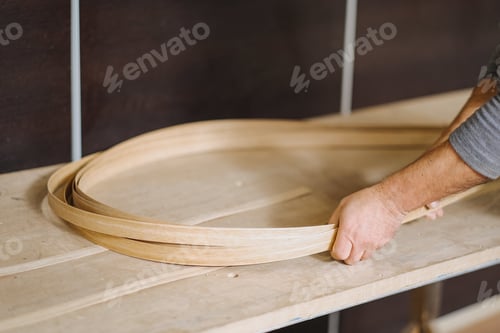 Preview: Closeup shot of a carpenter holding thin wood strands