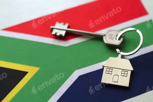 Preview: South African flag and key with house keychain. Concept of buying or renting home
