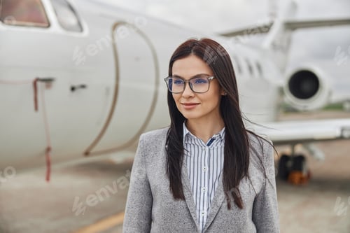 Preview: Professional Woman Posing near Private Airplane