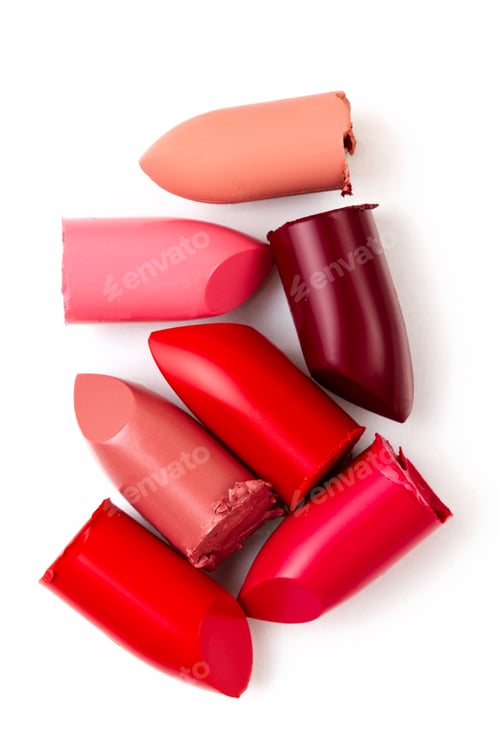 Preview: Collection of broken lipstick make up on white background. Make up artist, beauty salon, beauty blog