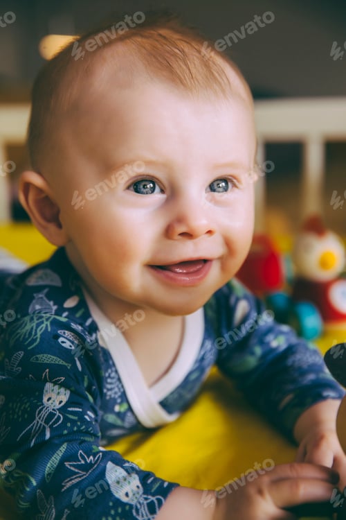 Preview: Portrait of happy baby boy in his crib