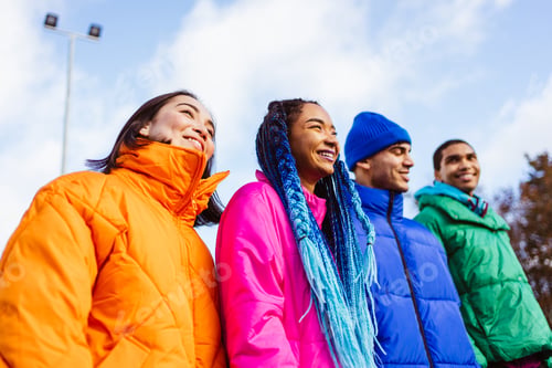 Preview: Multiracial group of young friends meeting outdoors in winter