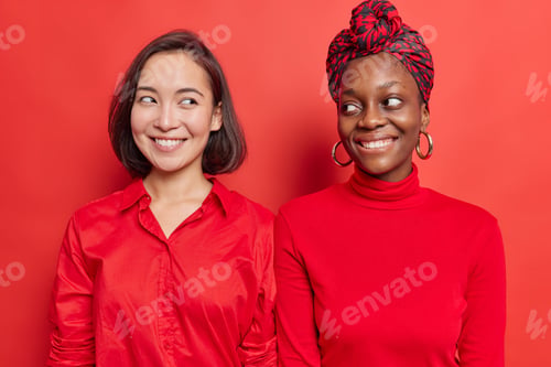 Preview: Horizontal shot of happy young women look gladfully at each other have toothy smiles glad to meet we