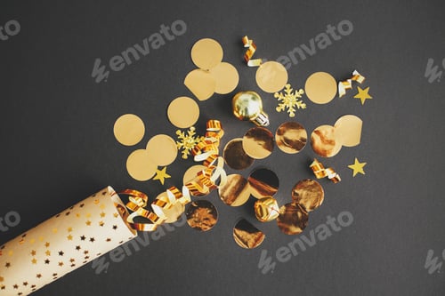 Preview: Modern golden confetti popping on black paper, new year firework creative flat lay. Happy New Year