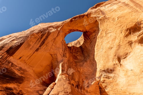 Preview: Window arch stands out against a backdrop of a clear blue sky, Suns Eye, Monument Valley, Arizona