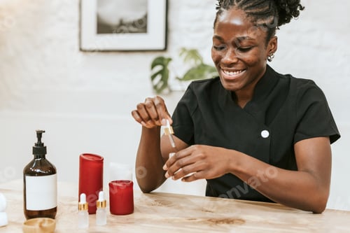 Preview: African American woman holding dropper bottle in spa