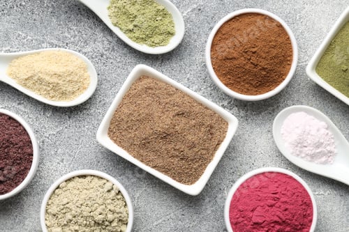 Preview: Different superfood powders on grey textured table, flat lay