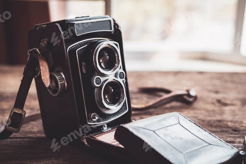Preview: Old retro camera on old wooden background