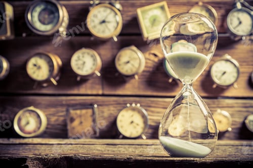 Preview: Vintage hourglass on the background of clocks